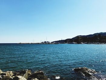 Scenic view of sea against clear blue sky