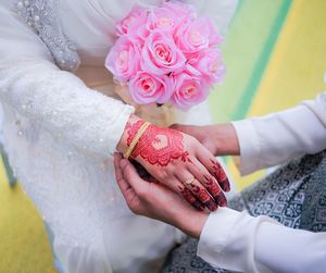 Midsection of woman holding bouquet