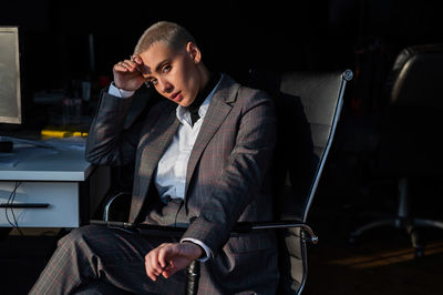 Young man sitting on chair at home