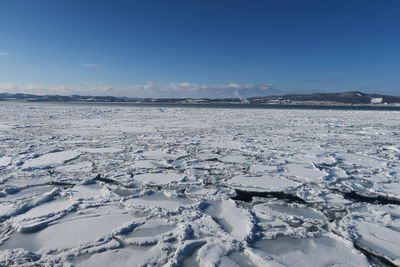 Scenic view of frozen lake against sky