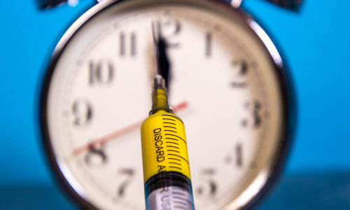 Close-up of clock against blue background