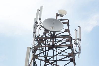 Low angle view of communications tower against sky