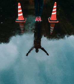 Low section of man standing on puddle