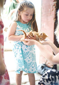 Girl holding kitten