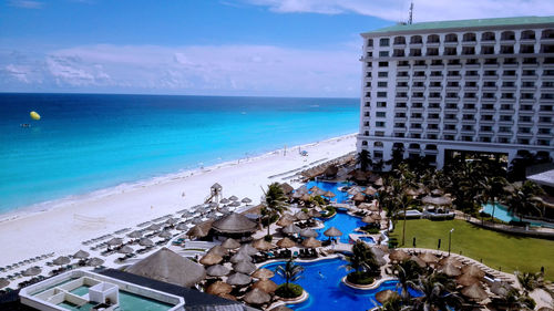 View of swimming pool by sea against sky