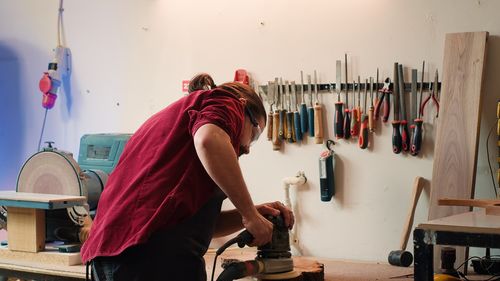 Rear view of man working in workshop