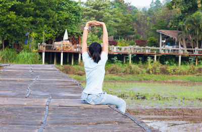 Rear view of woman on wooden wall