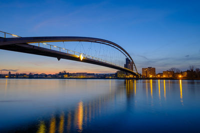 View of bridge over river against blue sky