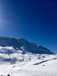 Scenic view of mountains against clear blue sky