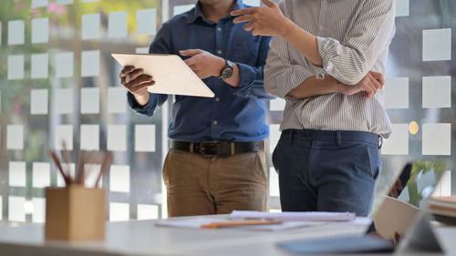 Midsection of business people working in office