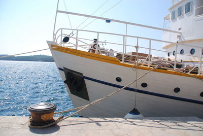 Sailboats moored on sea against clear sky