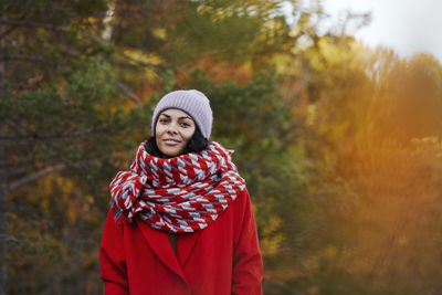 Portrait of young woman standing in forest