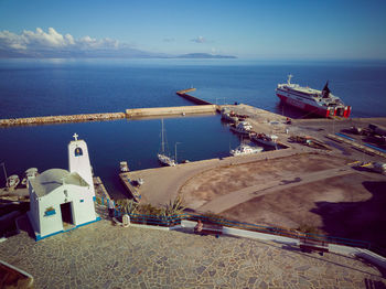 High angle view of commercial dock by sea against sky