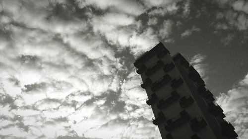 Low angle view of building against cloudy sky