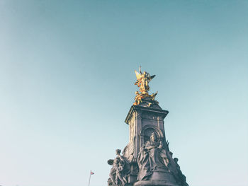 Low angle view of statue of liberty against sky