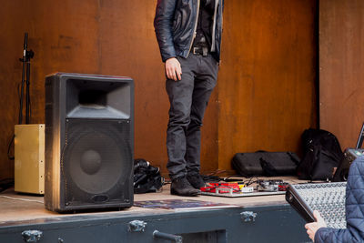 Low section of musician standing by speaker on stage