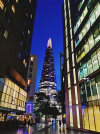 Low angle view of illuminated buildings in city at night