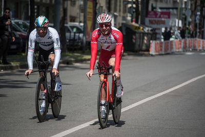 People riding bicycle on road