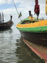 Boats moored in sea against sky