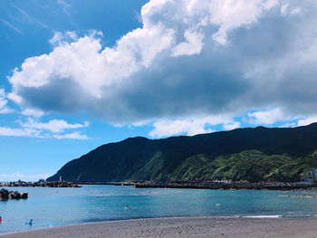 Scenic view of sea and mountains against sky