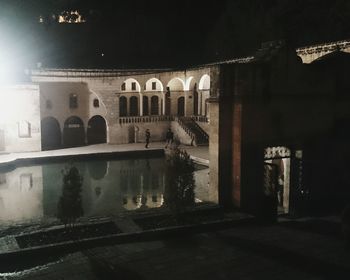 Reflection of illuminated building in city at night