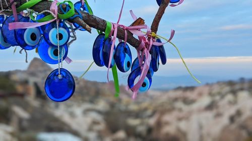 Close-up of multi colored umbrellas hanging on rope