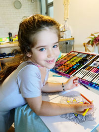 Portrait of cute girl studying at home