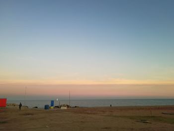 Scenic view of beach against sky during sunset