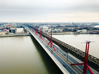 High angle view of bridge over river in city against sky