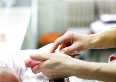 Cropped image of woman holding hands