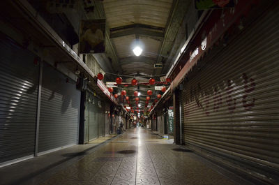 Empty corridor in illuminated building