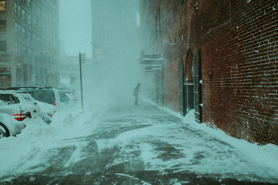 Snow covered car in city