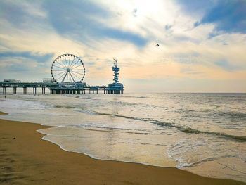 Ferris wheel at beach during sunset