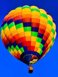 Low angle view of hot air balloon against blue sky