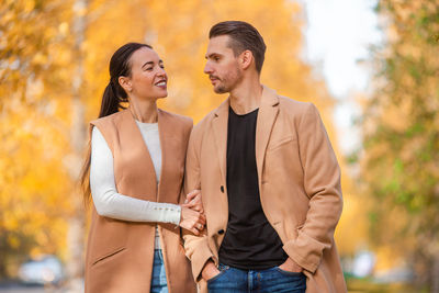 Young couple standing outdoors during autumn