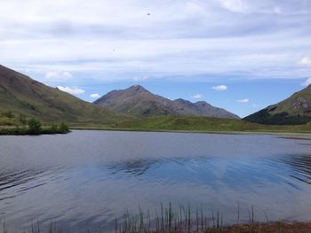 Scenic view of lake and mountains against sky