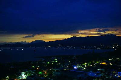 High angle view of illuminated cityscape against sky at night