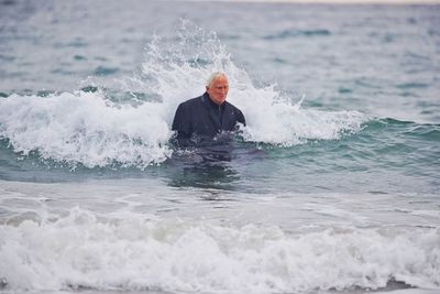 Businessman standing in sea