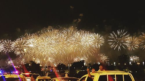 Low angle view of firework display at night