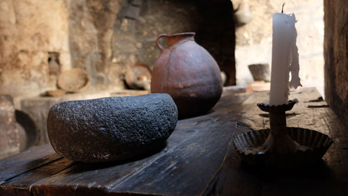 Antique bowl and candle on table