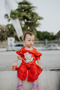 Cute girl with toy standing outdoors