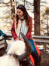 Close-up of woman sitting on yak