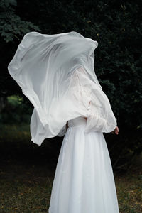 Rear view of woman standing in forest