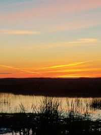 Scenic view of lake against sky during sunset