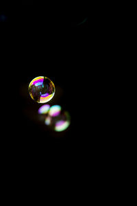 Close-up of bubbles over black background