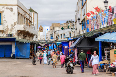 People walking on street market in city