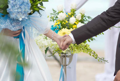 Midsection of woman holding flower bouquet