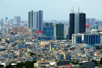 Modern buildings in city against sky