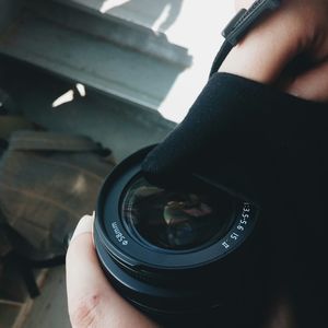 Cropped image of hand holding smart phone