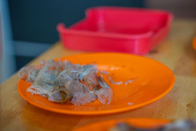 Close-up of fresh red chili peppers in plate on table